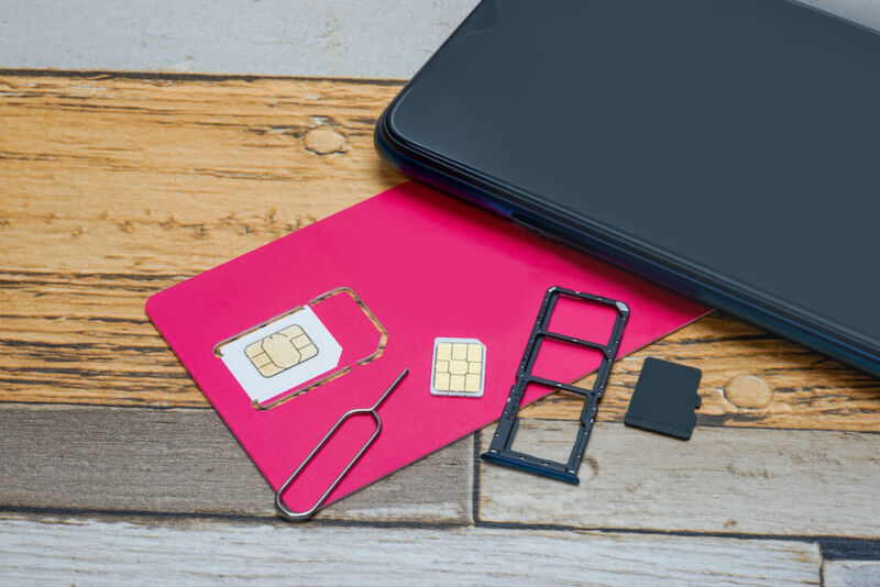 Small electronic devices spread across a faux wood surface.