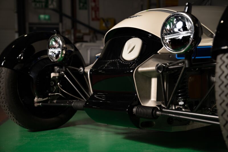 The front of a Morgan XP-1, you can see the suspension elements and the headlights and a charge port on the nose